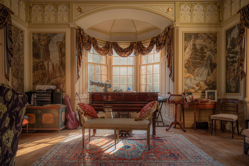 Bay window, grand piano and painted panels. Ballroom