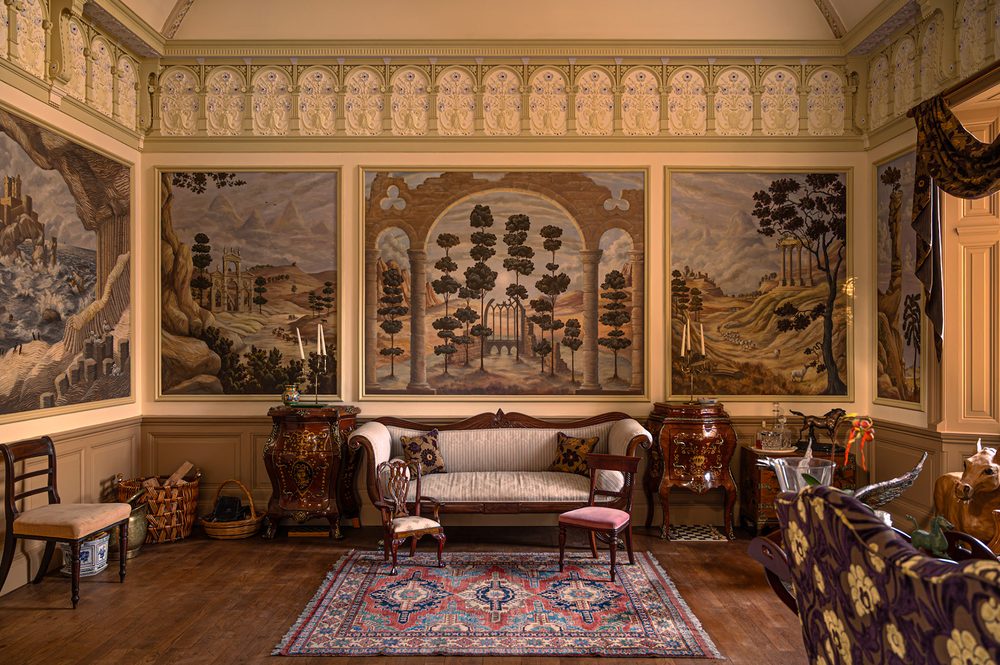 Painted landscape panels above the sofa. Ballroom