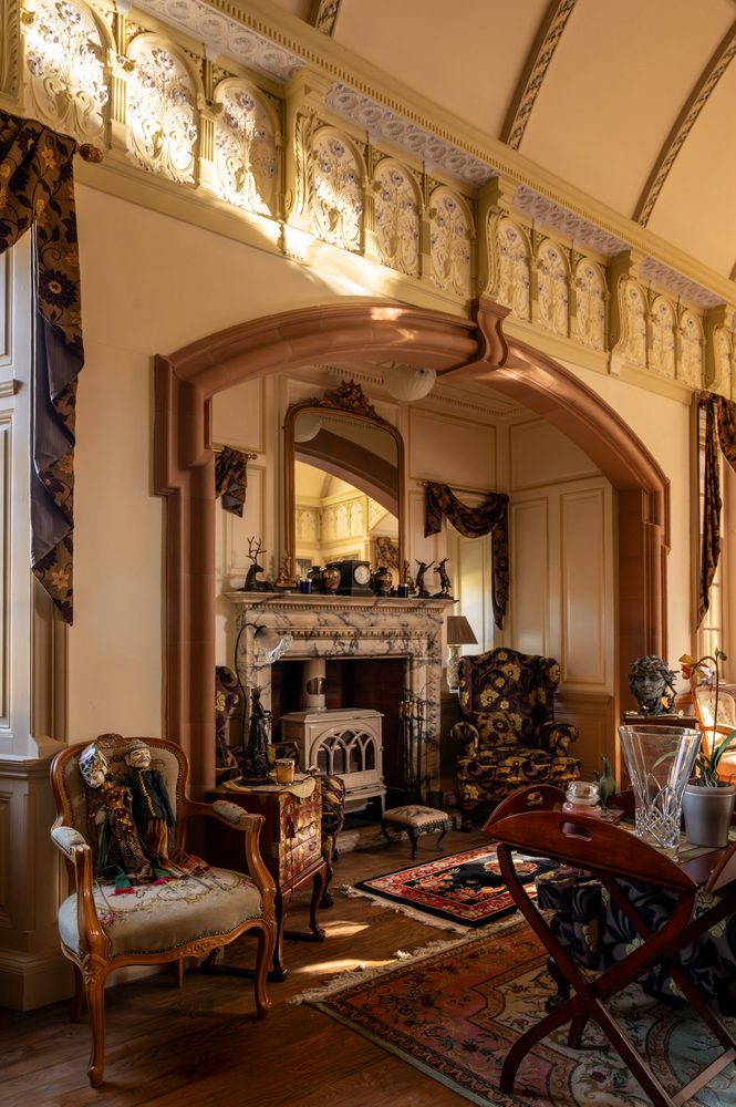 Arched opening to the hearth, plaster frieze above. Ballroom