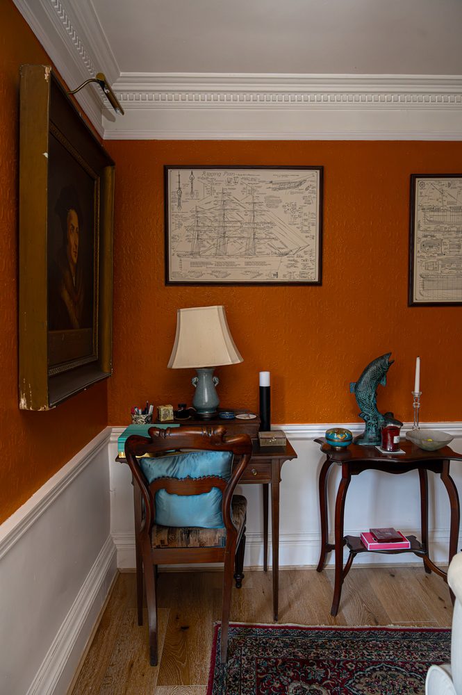 Framed maps, lamp and writing table