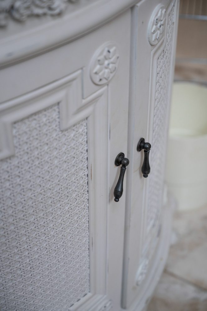 Carved cabinet door and cane panel