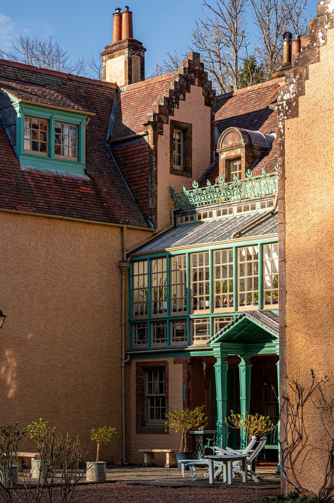 Cast-iron veranda against harled walls
